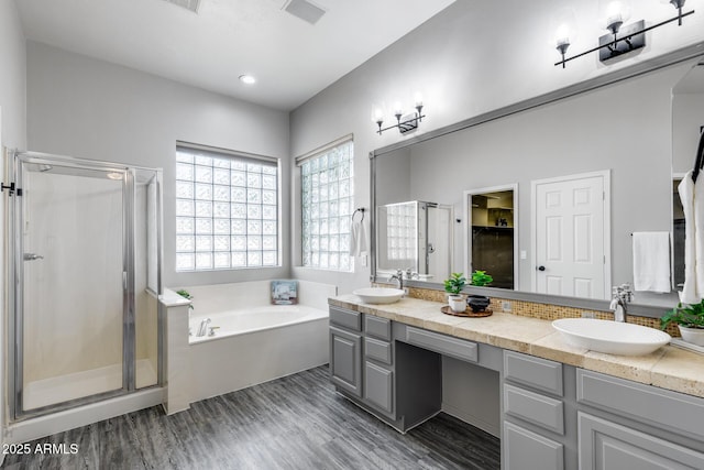 6742 W El Cortez Pl, Peoria, AZ 85383 - bathroom with a bath, a stall shower, wood finished floors, and double vanity