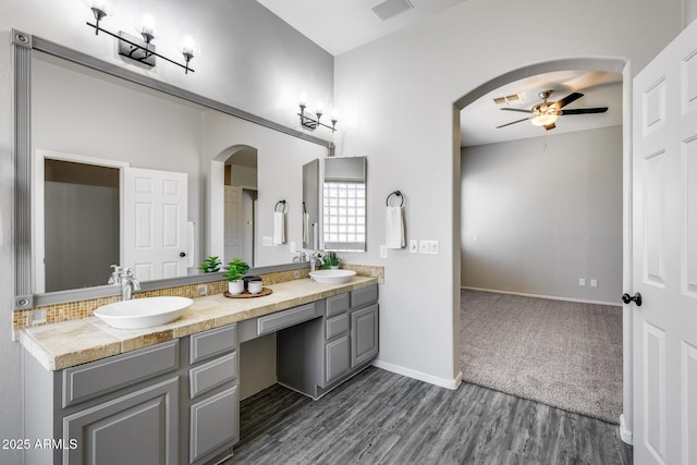 6742 W El Cortez Pl, Peoria, AZ 85383 - bathroom with a ceiling fan, double vanity, wood finished floors, and baseboards