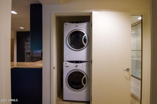 washroom featuring stacked washing maching and dryer