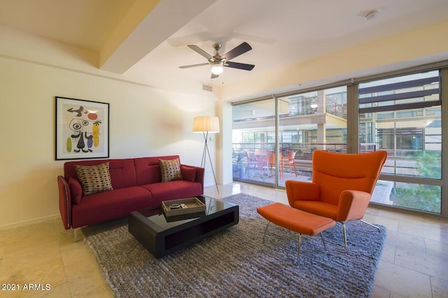 living room featuring ceiling fan and a healthy amount of sunlight