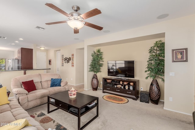 carpeted living room featuring ceiling fan