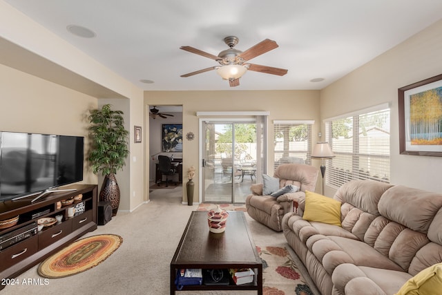 carpeted living room with ceiling fan