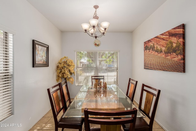 tiled dining area with a notable chandelier