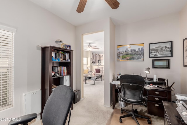 home office with light carpet, plenty of natural light, and ceiling fan