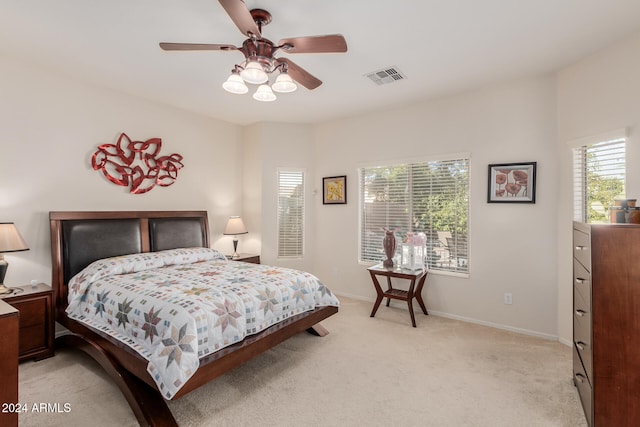 bedroom with ceiling fan and light colored carpet