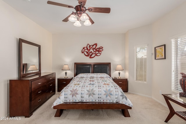 bedroom featuring ceiling fan and light colored carpet