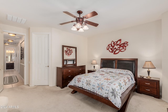 bedroom featuring ceiling fan and light carpet