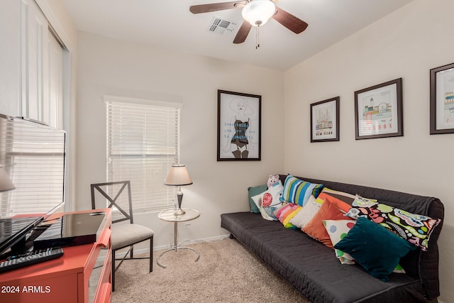 carpeted living room featuring ceiling fan