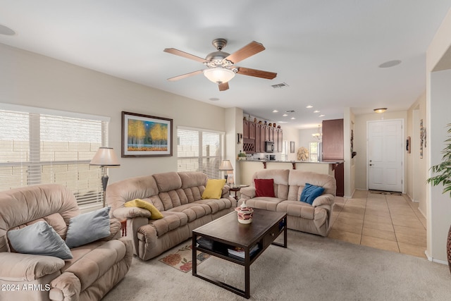 living room featuring ceiling fan and light tile patterned floors