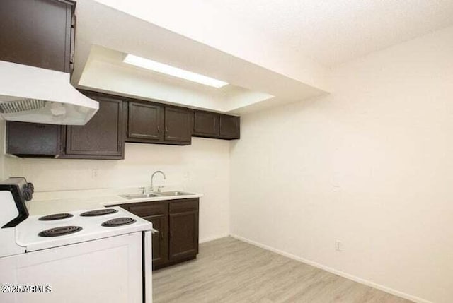 kitchen with light wood-style flooring, dark brown cabinetry, a sink, light countertops, and white range with electric cooktop