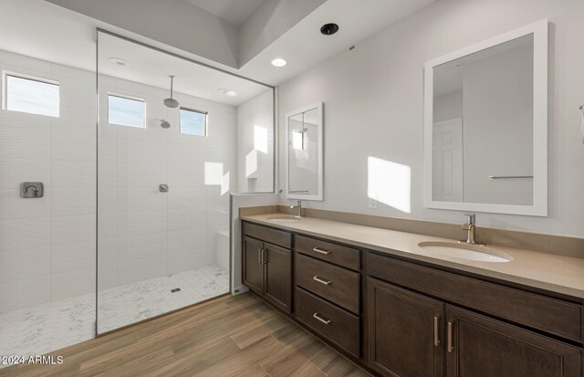 bathroom featuring tiled shower and vanity