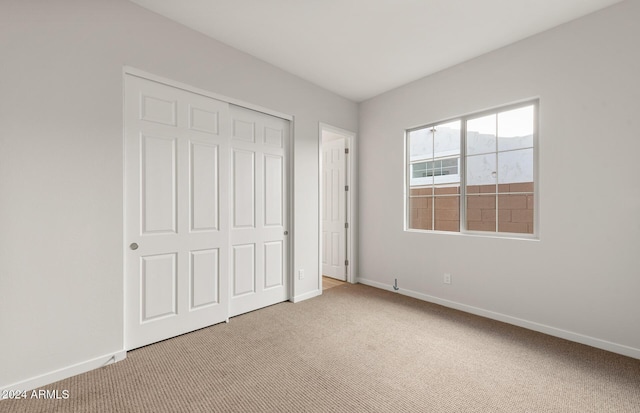 unfurnished bedroom featuring a closet and carpet floors