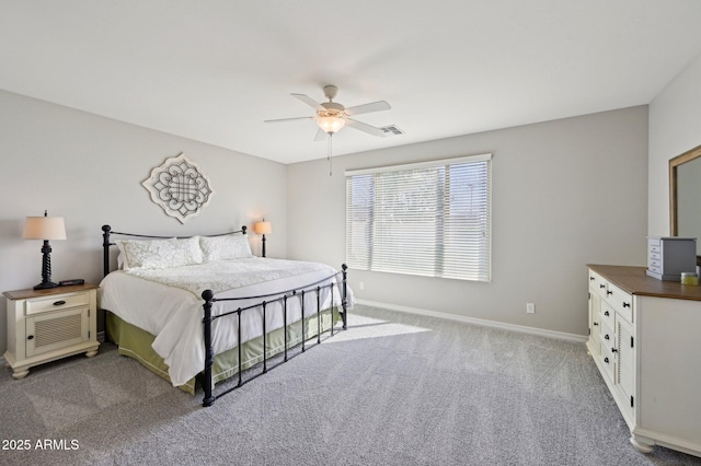 carpeted bedroom featuring visible vents, baseboards, and ceiling fan