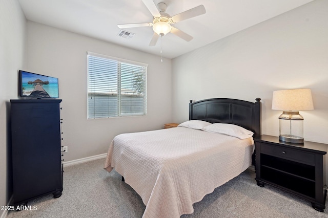 carpeted bedroom with a ceiling fan, baseboards, and visible vents