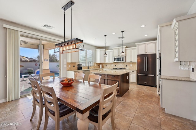 dining area with light tile patterned flooring, visible vents, and recessed lighting