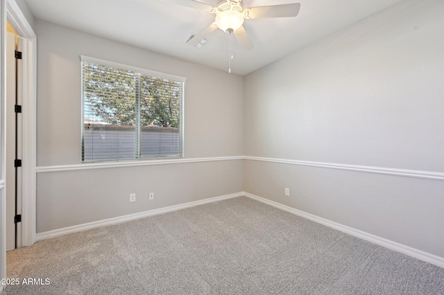 spare room featuring baseboards, carpet floors, and ceiling fan