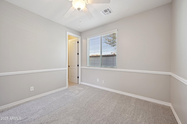 unfurnished room with visible vents, baseboards, carpet, and ceiling fan