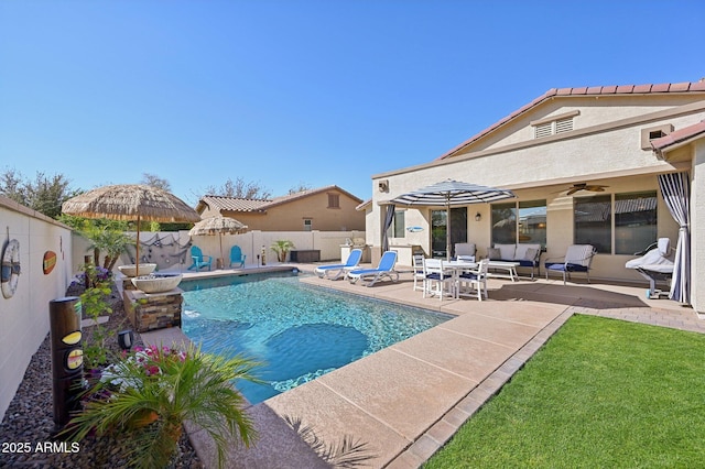 view of swimming pool with a patio area, a fenced in pool, a ceiling fan, and a fenced backyard