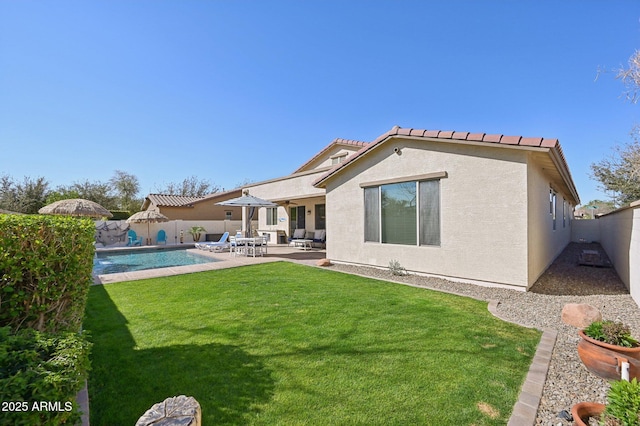 rear view of property with stucco siding, a patio, a fenced backyard, a yard, and a fenced in pool