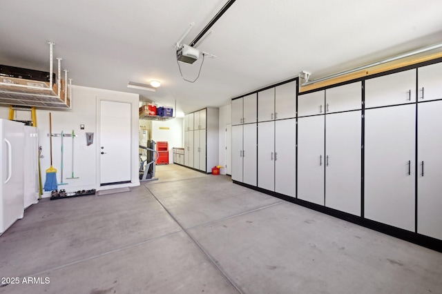 garage with a garage door opener and freestanding refrigerator