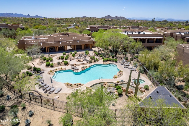 view of swimming pool featuring a mountain view and a patio