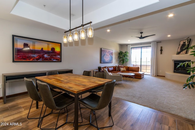 dining room with dark colored carpet and ceiling fan