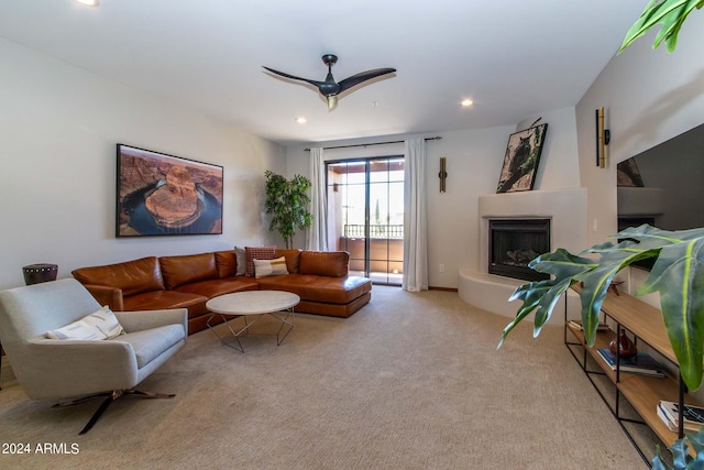 carpeted living room with ceiling fan