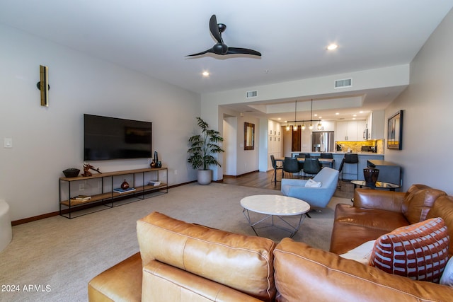 carpeted living room featuring ceiling fan