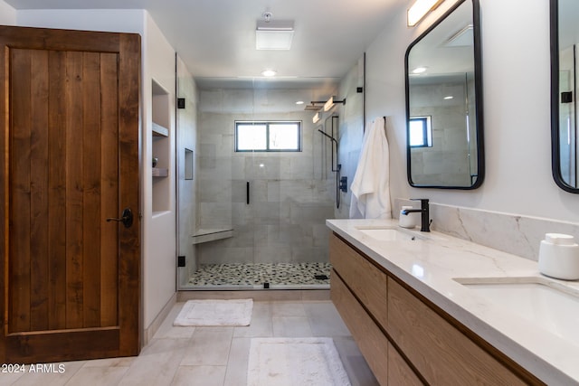 bathroom with dual bowl vanity, an enclosed shower, and tile floors