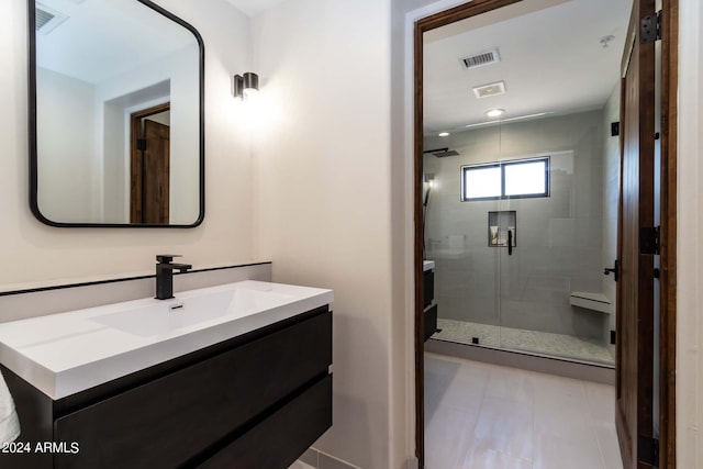 bathroom featuring tile flooring, walk in shower, and vanity