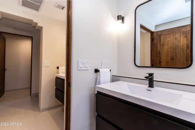 bathroom featuring vanity and tile floors