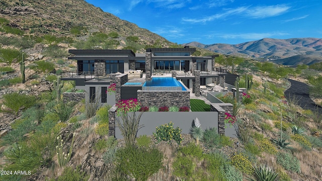 back of house with a patio, a balcony, and a mountain view