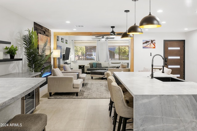 interior space featuring decorative light fixtures, visible vents, recessed lighting, and a sink