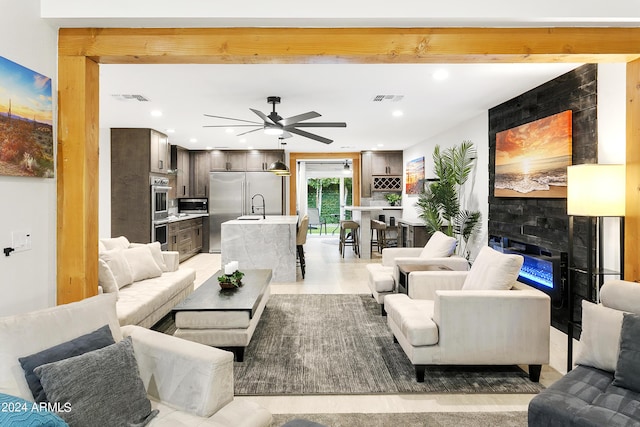 living room featuring visible vents, recessed lighting, a fireplace, and a ceiling fan