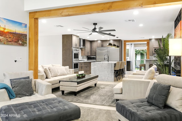 living room with recessed lighting, visible vents, and a ceiling fan