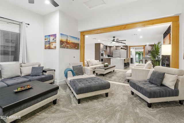 living room with light carpet, visible vents, recessed lighting, and a ceiling fan