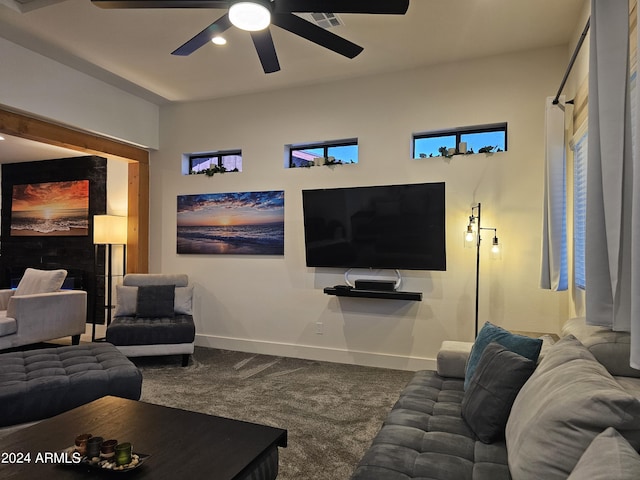 carpeted living room with a ceiling fan and baseboards