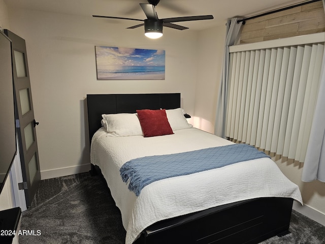 bedroom with baseboards, dark colored carpet, and ceiling fan
