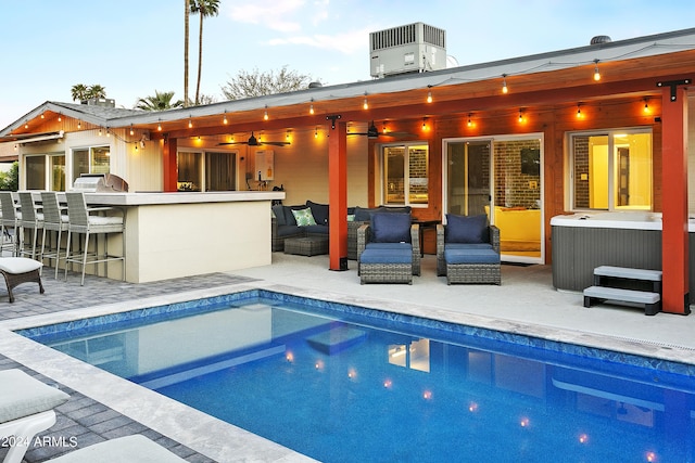 back of house with outdoor dry bar, an outdoor living space, central AC, an outdoor pool, and a patio