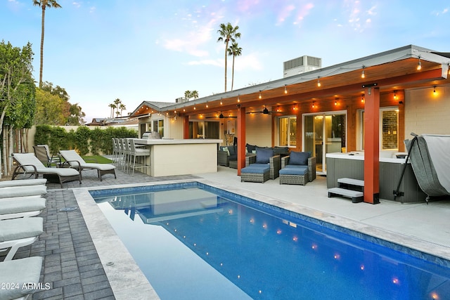 view of pool featuring outdoor dry bar, an outdoor living space, a fenced in pool, and a patio