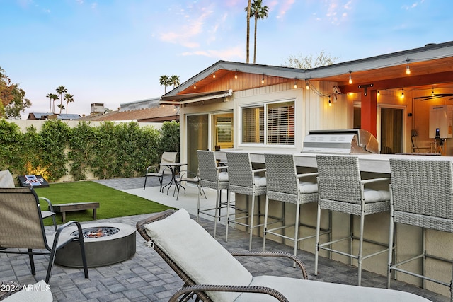 view of patio with a bar and an outdoor fire pit