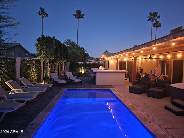view of pool featuring a patio area, outdoor dry bar, and fence