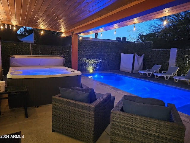 view of swimming pool featuring a patio, a covered hot tub, and a fenced backyard