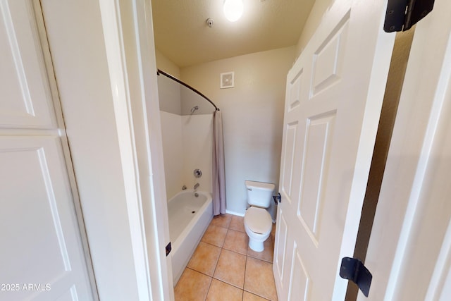 bathroom with tile patterned floors, shower / bathtub combination, and toilet