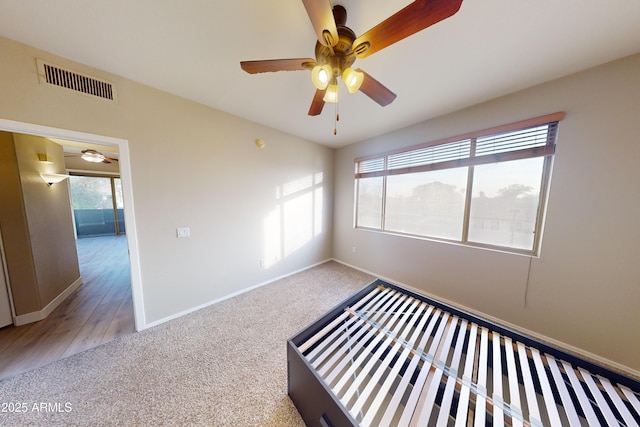 unfurnished bedroom featuring carpet floors and ceiling fan