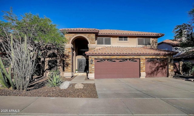 mediterranean / spanish house with a garage