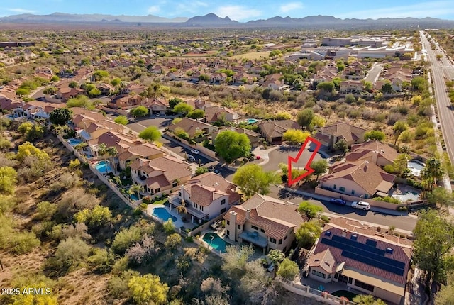 birds eye view of property featuring a mountain view