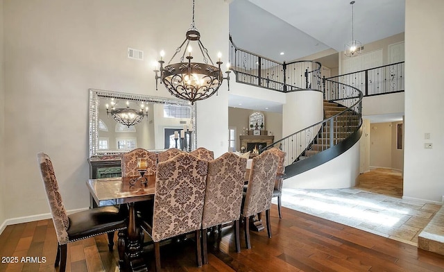 dining room with a towering ceiling and hardwood / wood-style flooring