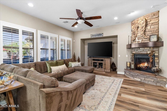 living area with visible vents, ceiling fan, wood finished floors, a fireplace, and recessed lighting