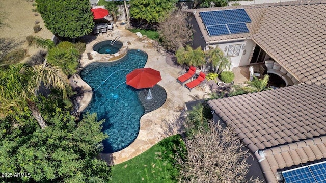 outdoor pool featuring a patio and an in ground hot tub